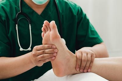 Medical examination of athlete’s foot by podiatrist